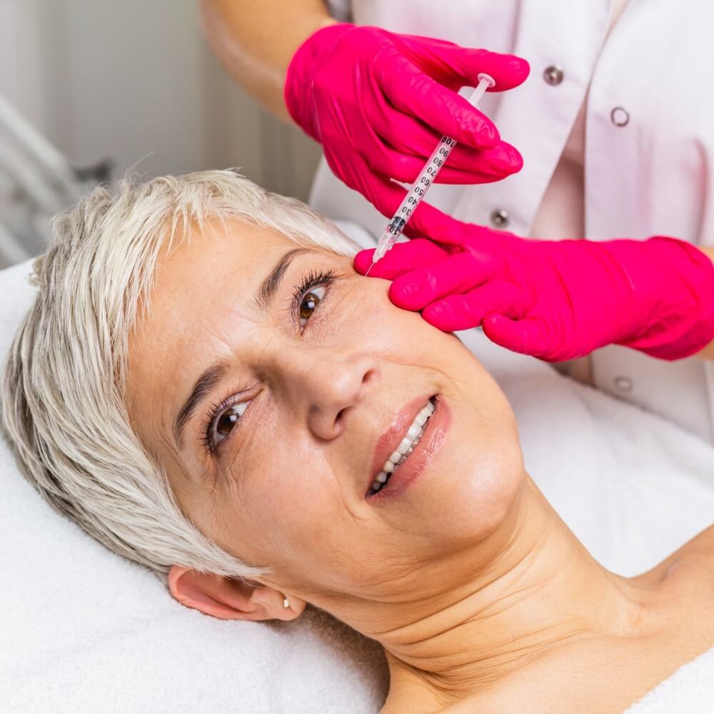 Mature woman is getting a rejuvenating facial botulinum injections, aesthetics, iv infusion therapy, anti-aging treatment